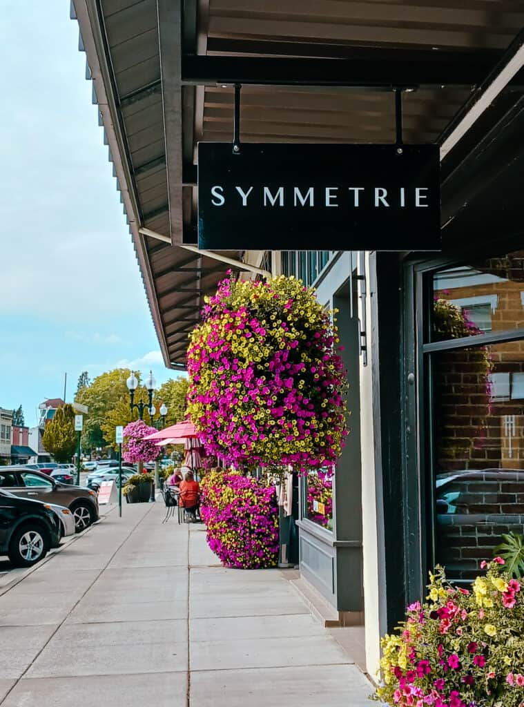 colorful handing baskets and planter lining a sidewalk, downtown lynden wa