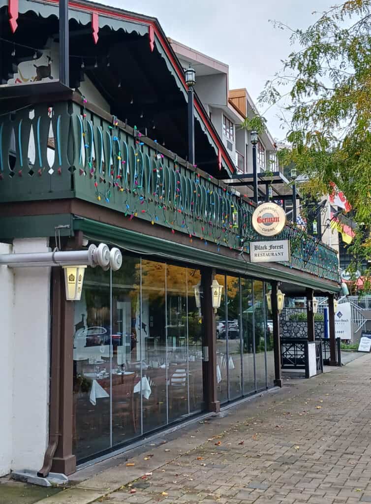 exterior of German restaurant with a bavarian chalet style and green balcony railing