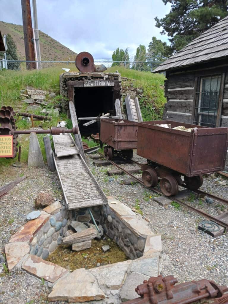 mining carts rusted outside a fake mining entrance, Cashmere pioneer village